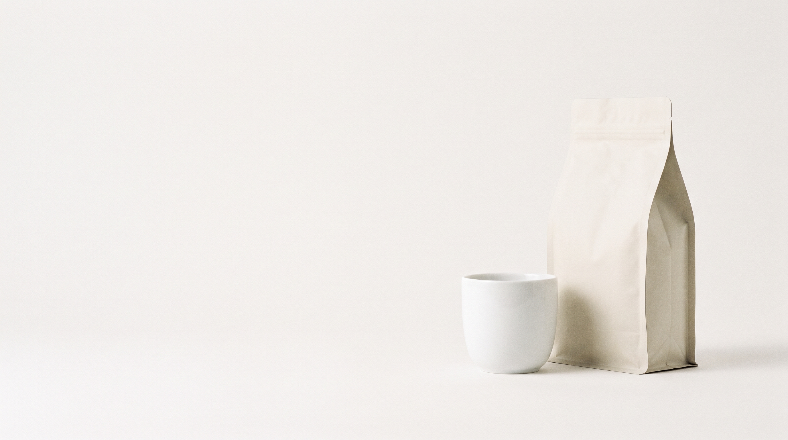 A Morning Brew Co coffee bag and ceramic cup on a warm cream backdrop